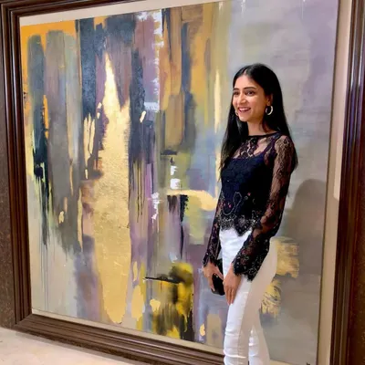 Standing next to "Dusk," a massive 6x5.75 ft custom abstract piece. This painting was commissioned to fill a large wall, using a palette of grays, purples, and shimmering gold leaf to create a dramatic, atmospheric effect.