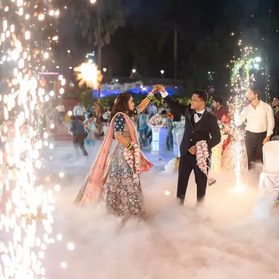 The couple's magical first dance at their reception, surrounded by sparklers and fog. I use these elements to create truly spectacular and memorable wedding reception photography.