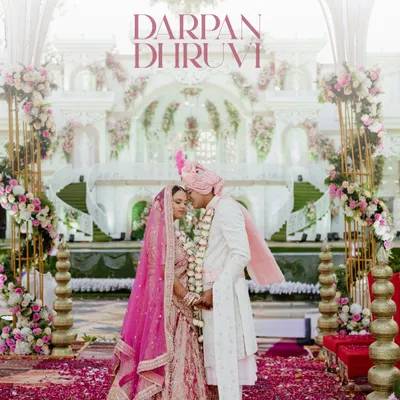 A moment of quiet connection amidst the grandeur of the wedding ceremony. We framed this shot to highlight the stunning decor and the intimate bond between the couple, creating a perfect blend of scale and emotion.