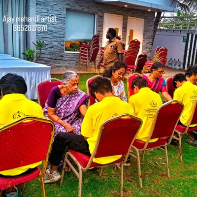 Our team of artists, all in uniform, working efficiently at an outdoor event. We set up to handle multiple guests at once, making the process smooth for large gatherings like weddings and sangeet parties.