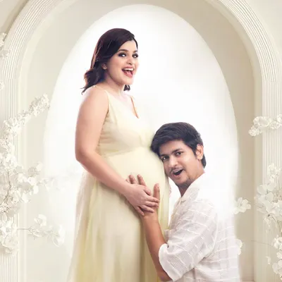 A sweet and playful moment as the dad-to-be listens to the baby bump. This is a classic couple pose that always brings out genuine smiles, captured here in my bright and airy studio.