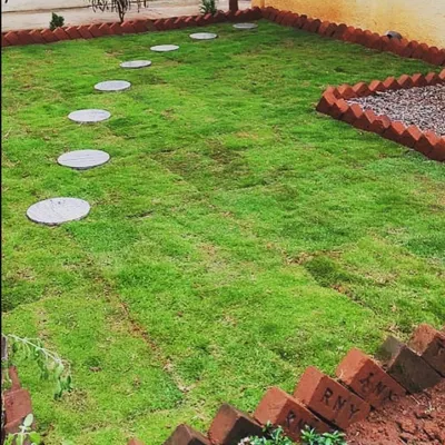 Our work extends to ground-level landscaping. This project involved laying natural grass sod, creating a clean brick border, and placing stepping stones for a classic garden path.