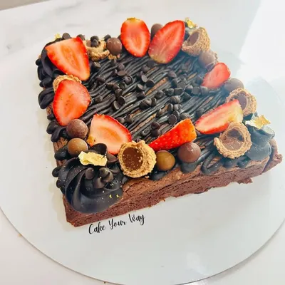 This isn't just a brownie, it's a brownie cake. I take my signature fudgy brownie and load it up with chocolate drizzle, fresh strawberries, and an assortment of chocolate treats for an over-the-top dessert experience.