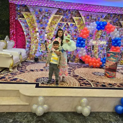 A birthday party fit for a princess. I designed this lavish stage with a massive floral wall and a custom balloon arch, creating a beautiful backdrop for the cake cutting and photos.