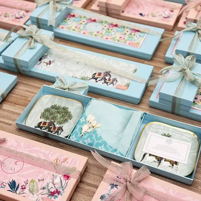 For one wedding, we created hundreds of these bespoke favour boxes in delicate pink and blue. Each set contained custom-printed serveware, reflecting the couple's aesthetic and creating a cohesive, beautiful memory for their guests.