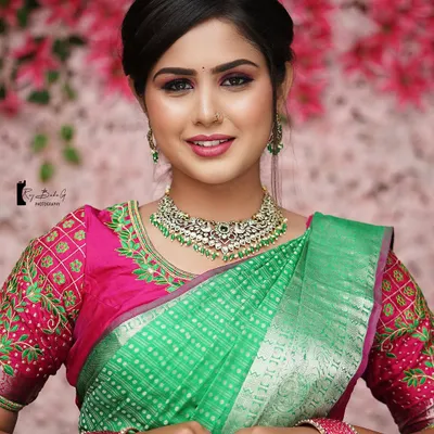 A beautiful smile from our model during a live demonstration for Batch 11. This look features a classic South-Indian bridal style with bold eyes and a balanced lip color, perfect for wedding ceremonies.