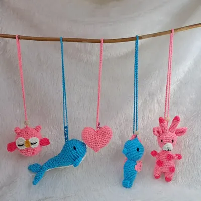 A lineup of my adorable car or cradle hanging charms. This collection shows a sleepy pink owl, a blue whale, a pink heart, a blue seahorse, and a pink giraffe.