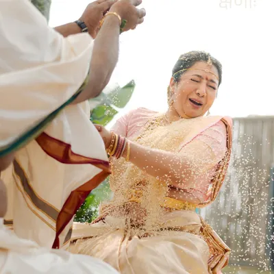The Talambralu ritual in a South Indian wedding is a moment of pure, uninhibited joy. I captured the bride's wonderful reaction as she is showered with rice and pearls. This is a perfect example of a precious, candid moment, a true 'kshanaah amoolya'.