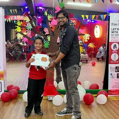 A proud camper receiving her certificate of appreciation at the April batch showcase. These moments are what make the camp experience so memorable.