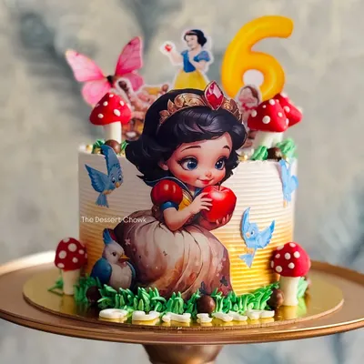 A fairytale come to life with this Snow White themed tall cake. I used edible prints and fondant mushrooms to create an enchanted forest scene for a 6th birthday.