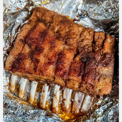 A full rack of my grilled pork spare ribs, marinated overnight in a homemade spice rub and slow-grilled for six hours until the meat is fall-off-the-bone tender.