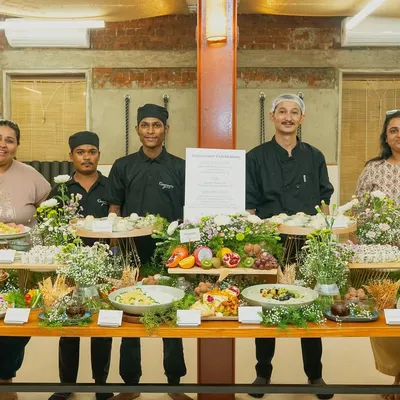 The Gourmetly Yours team posing proudly behind a beautiful grazing table at a corporate anniversary event. We are thrilled to bring our signature touch to every celebration.