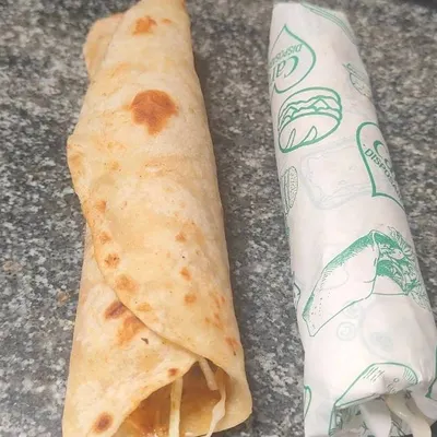 An open paneer roll sits beside a wrapped one in this close look at the rolls we offer for snack orders.