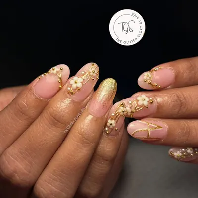 A full view of a custom bridal press-on set featuring 3D floral details, a glitter accent nail, and a personalized initial. I work with brides to create a design that is completely unique to their style.