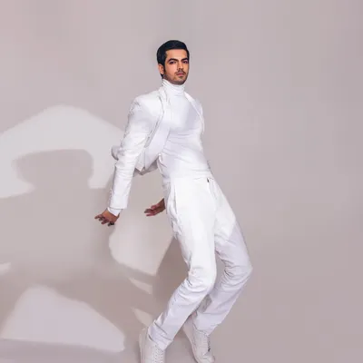 A minimalist all-white look styled for designer Line by Shamim Khan. The cropped jacket and clean lines create a modern and sharp silhouette, showcasing a contemporary take on the classic pantsuit.