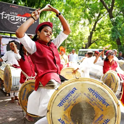 The passion of performance on full display. This dhol player is captured mid-motion, showcasing the intensity and skill involved in the Gudi Padwa celebrations.