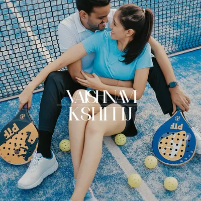 A fun and romantic themed shoot on a Padel court, with the couple seated amidst rackets and balls.