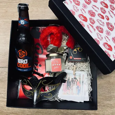 A kinky hamper for your girl to "kiss the miss goodbye." This bachelorette box includes a "Bro Code" beer, a masquerade mask, red furry handcuffs, a scented candle, and polaroids of her squad.