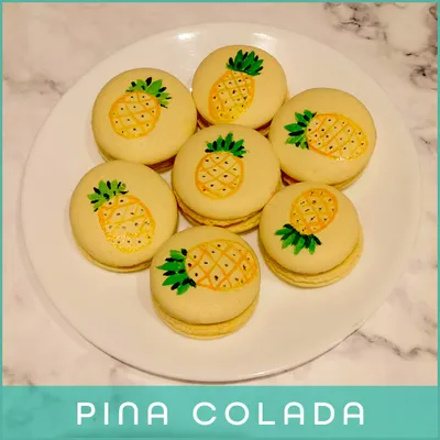 Transport yourself to a tropical paradise with our Pina Colada macarons. These are hand-painted with cute pineapples and filled with a delicious coconut and pineapple ganache.