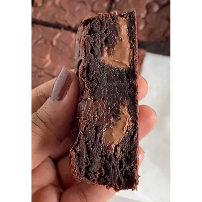 This is the texture you can expect from my gooey fudgy brownies. I use premium couverture chocolate to create that signature molten center and rich, deep flavor. All my brownies are eggless.