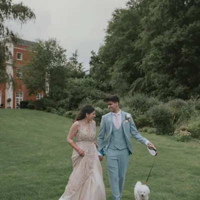 A lovely candid moment from a wedding in Hampshire, UK, as the couple takes a stroll with their furry friend. We love incorporating personal elements like pets into our couple portraits.
