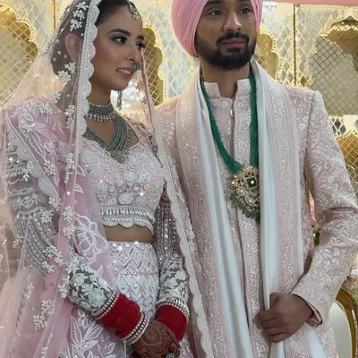 A beautiful couple portrait from a pastel-themed Anand Karaj. The bride's makeup is soft and romantic, with pink tones that perfectly complement her stunning Manish Malhotra lehenga.