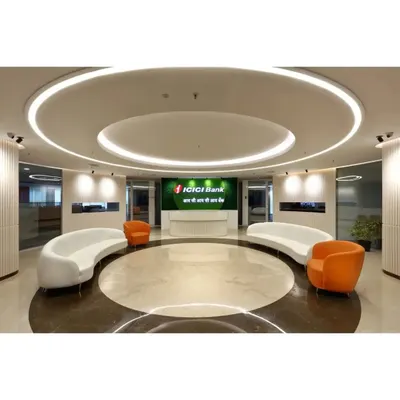The main lobby for ICICI Bank, designed with a circular motif, marble flooring, and custom curved sofas. The space is engineered to manage high footfall while projecting an image of modern financial leadership.