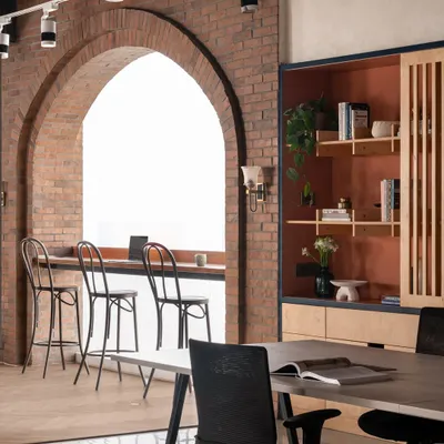 An office should inspire creativity. I designed our own studio with a statement brick arch to frame the large window, creating a bright space for brainstorming or a quiet coffee. It’s a nod to a warm, rustic style that feels both refined and welcoming.