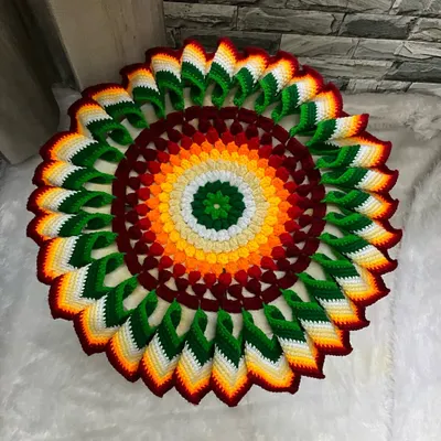 This is a 'Tatavaracha Rumal', a traditional decorative cover for a plate of food, often used during festivals. This one features a vibrant, multi-colored 3D petal design.