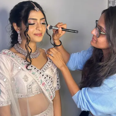 A candid moment of me in my element, adding the finishing touches to a beautiful client's makeup for her special event.
