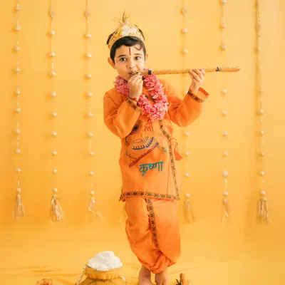 Our little Krishna, looking divine with his flute. We use a vibrant yellow backdrop and traditional props to create authentic and beautiful Janmashtami portraits.