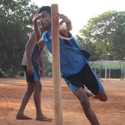 Mastering the pole is essential for any serious Kho-Kho player. Here, a player practices his pole turn, a key technique for quick direction changes while chasing.