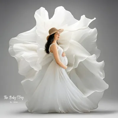 This is one of my signature styles, using flowing white fabric to create a dramatic, flower-like effect. It’s a powerful way to create an artistic and ethereal solo maternity portrait that celebrates the beauty of your pregnancy.
