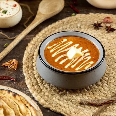 This shot captures the heart of North Indian cuisine. I used dark, moody lighting to emphasize the rich texture of the curry and the creamy swirl, making this classic dish feel both comforting and luxurious for a restaurant's menu.