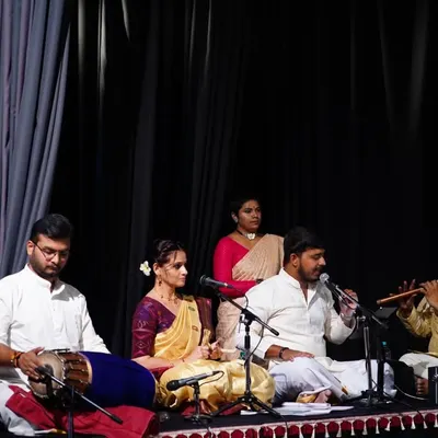 A glimpse into the soul of our performances, where music and dance become one. Here, you see our live orchestra, featuring talented vocalists, the melodic flute, and the rhythmic pulse of the mridangam, all coming together to create a truly divine experience on stage.