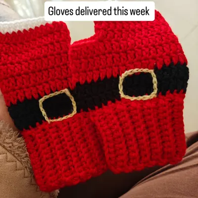A pair of Santa-themed fingerless gloves I crocheted, delivered just in time for the winter chill. The buckle detail makes them extra festive.