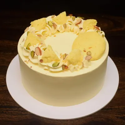 My Rasmalai fusion cake is a consistent bestseller. This one has a clean, smooth finish and is topped with pieces of rasmalai, pistachios, and saffron threads for an elegant and delicious dessert.