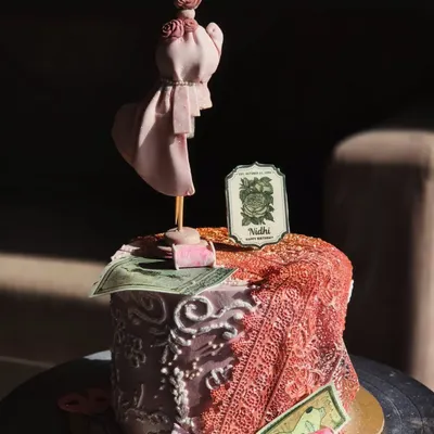This custom cake was made for a fashion student, and I had so much fun with the details. It features a handcrafted mannequin, edible fabric draping, and other design elements to capture her passion.