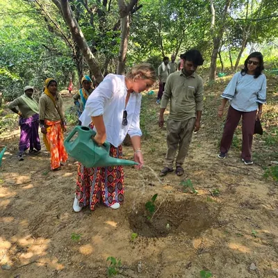A volunteer from NatWest Group India waters a newly planted native Aravali sapling at Ghata Bundh. This simple act is a vital step in ensuring the survival of young trees in our restoration projects.