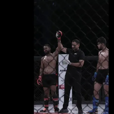 Our head coach, a certified referee, raising a fighter's hand in victory. His experience inside the cage as an official provides invaluable insight for our team.