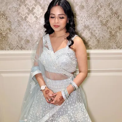 A lovely client ready for a party in a light blue lehenga. I gave her soft curls and a natural makeup look.