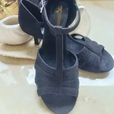 A close-up of the Classic Black suede heel, our flagship product. The multi-strap front and T-strap design provide maximum security, so you can focus on your moves without worrying about your footwear.