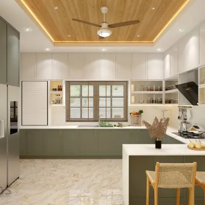 This award-winning kitchen from Mr. Aniketh's residence features a refreshing sage green and white color scheme. The design includes a breakfast counter, ample storage, and a wooden-paneled ceiling with integrated lighting for a bright and modern look.
