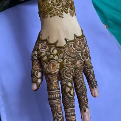 A random picture of a design I love. It features a floral cuff bracelet and a hand filled with intricate rose and leaf patterns.