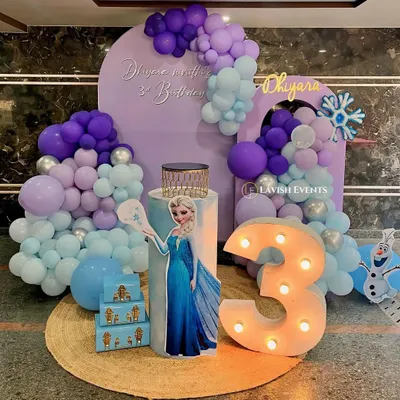 A magical Frozen-themed party for Dhiyara's 3rd birthday, featuring an Elsa cutout, a purple and blue balloon cascade, and a light-up marquee number.