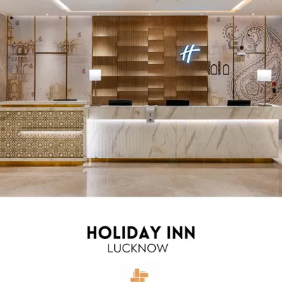 The main reception of Holiday Inn, Lucknow, serves as a contemporary welcome infused with local culture. The design features a sleek Italian marble desk, a textured wood backdrop, and wall graphics that echo the city's architectural motifs.
