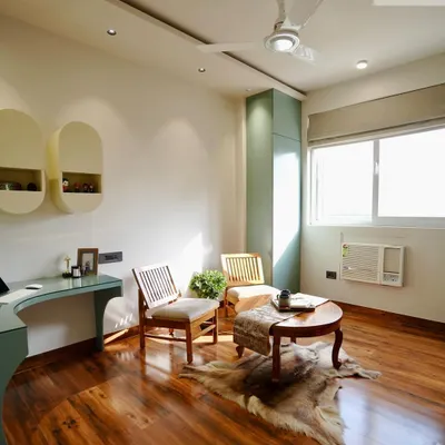 This sun-lit study room was designed to be a bright and comfortable multi-use space. It features a custom desk, ample natural light from the large window, and a cozy seating area for breaks or casual conversations.