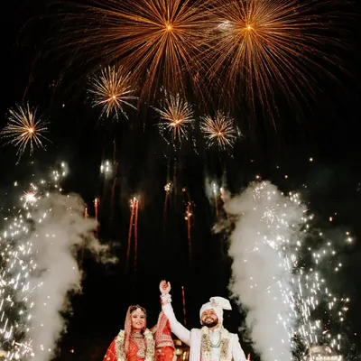 A spectacular wedding exit framed by an explosion of fireworks. We are experts at capturing these high-impact, dramatic moments.