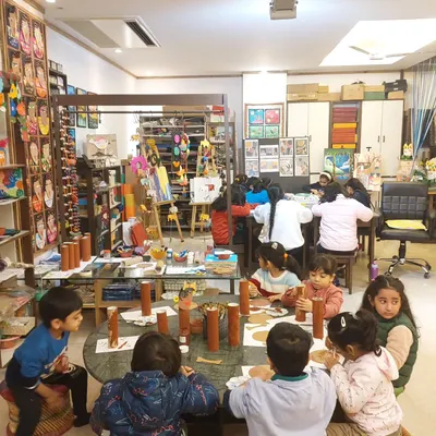 Here is a wide view of my cozy and colorful studio on a Saturday morning. It is the perfect environment for a fun and productive date with art, with spaces for different age groups and projects.