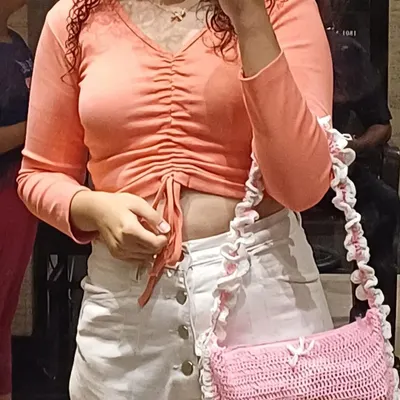 Another look at the pink ruffle bag being worn. It's a shoulder bag style that sits really comfortably and adds a cute touch to any outfit.